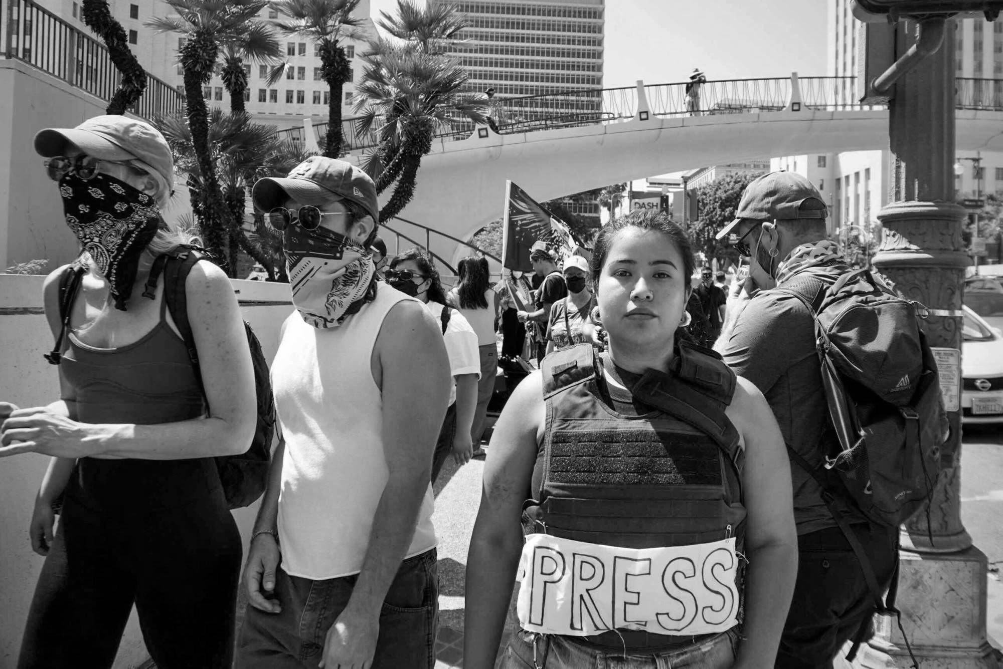 woman with vest that says press black and white image