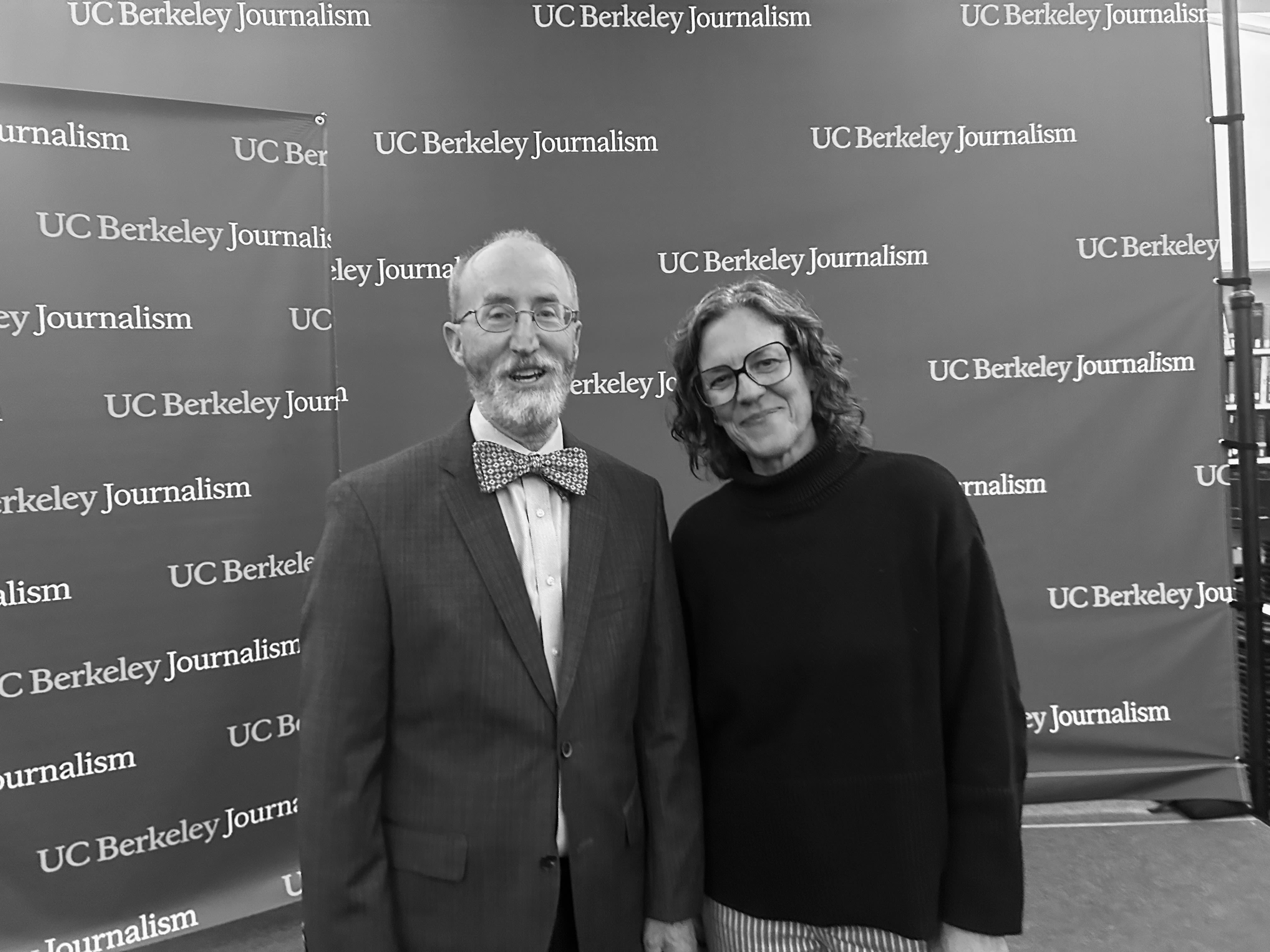 a woman and man smiling at the camera