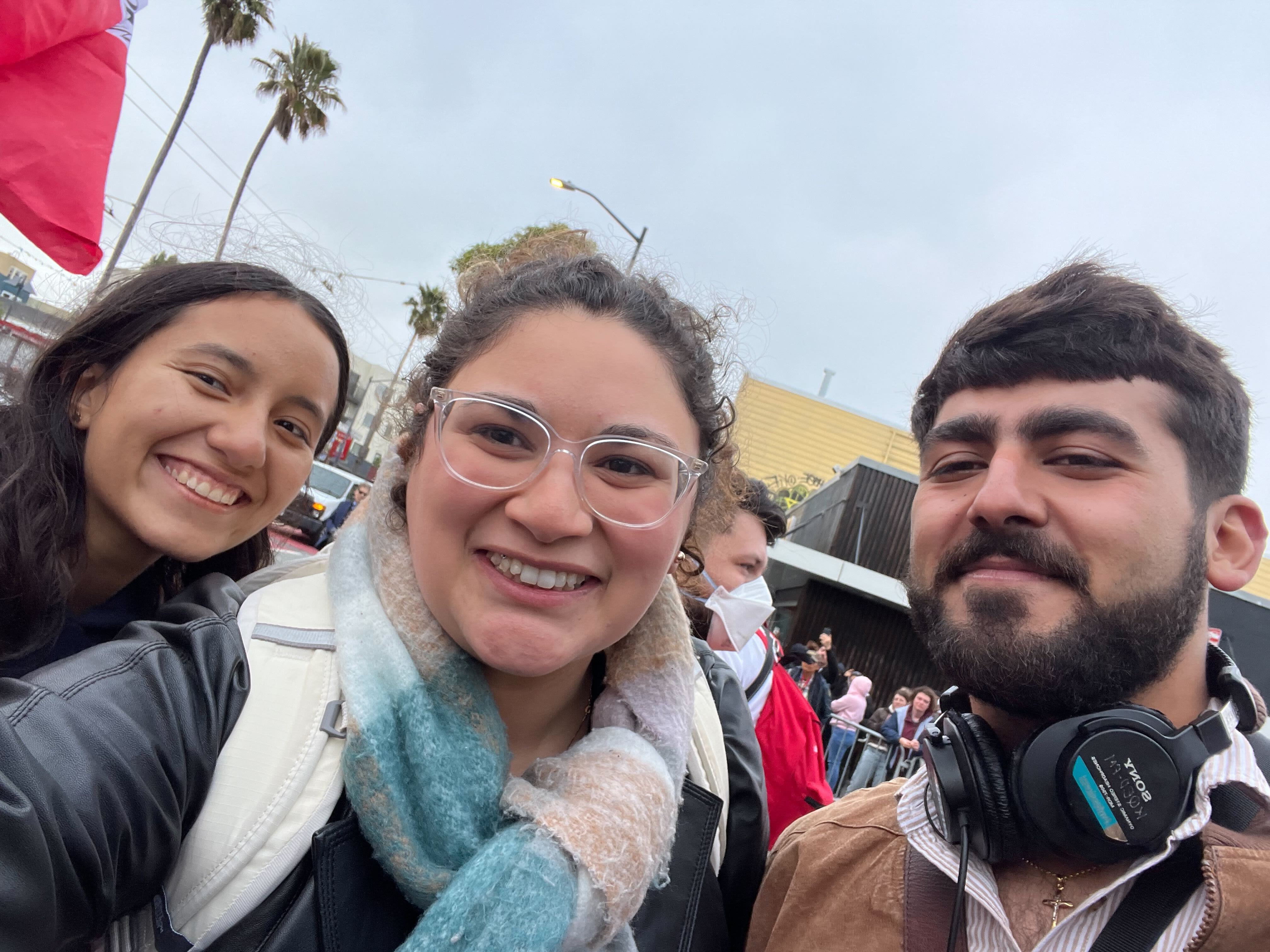 Woman photographs the border between the U.S. and Mexico. 