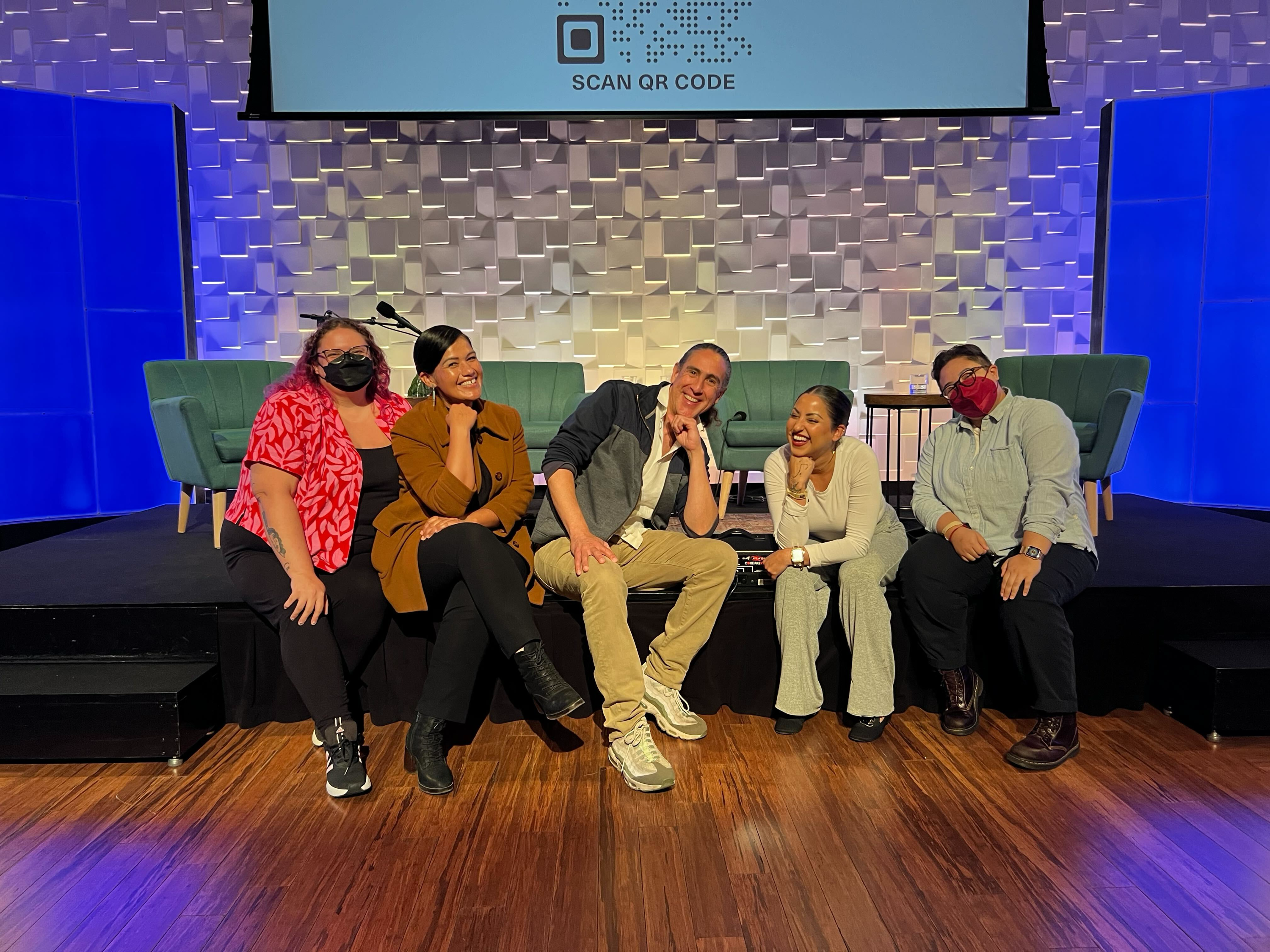 A group of people pose for the camera in slightly silly ways. 