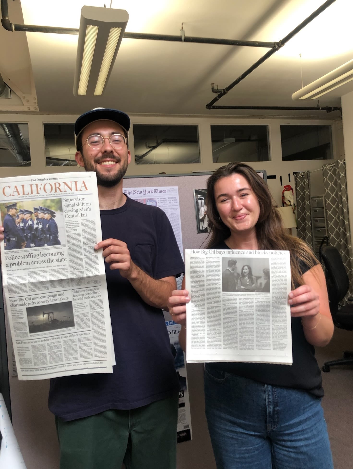 Photo of Max Harrison-Caldwell ('24) and Laura Fitzgerald ('24) showing their Los Angeles Times investigations article about charitable gifts and Big Oil in California.