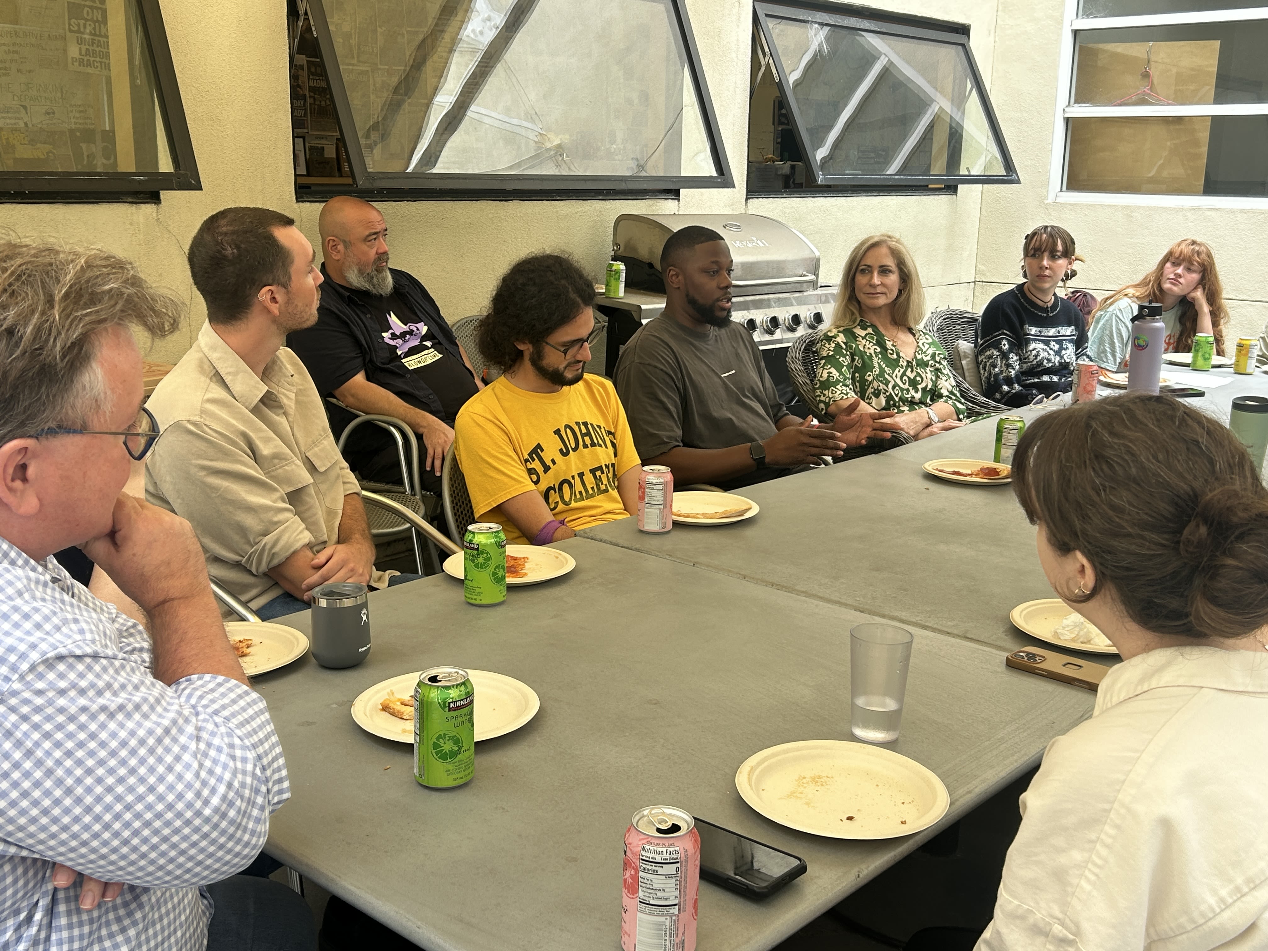 A group sits around a table in the IRP courtyard. 