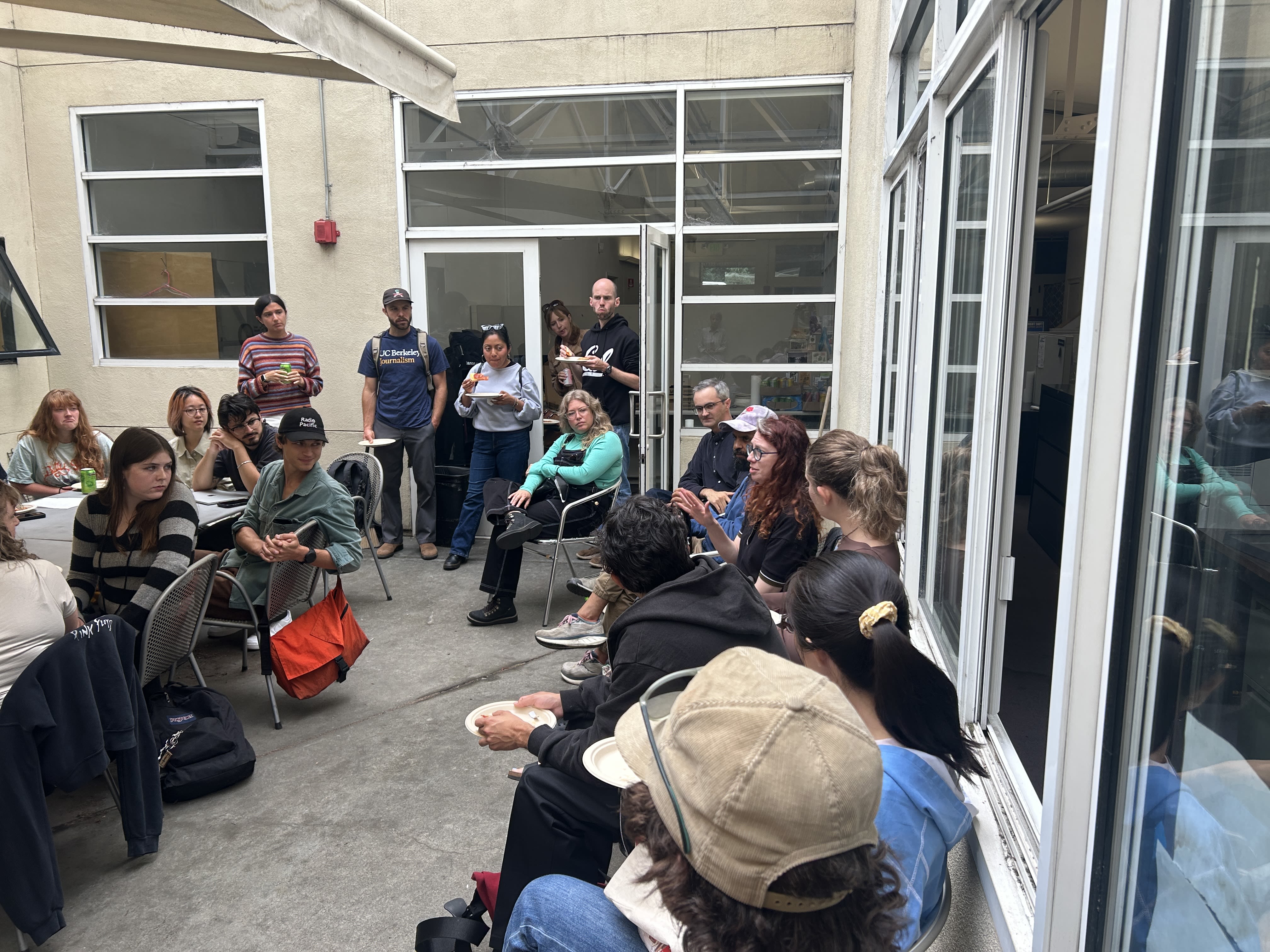 A group of people sitting in the IRP courtyard. 