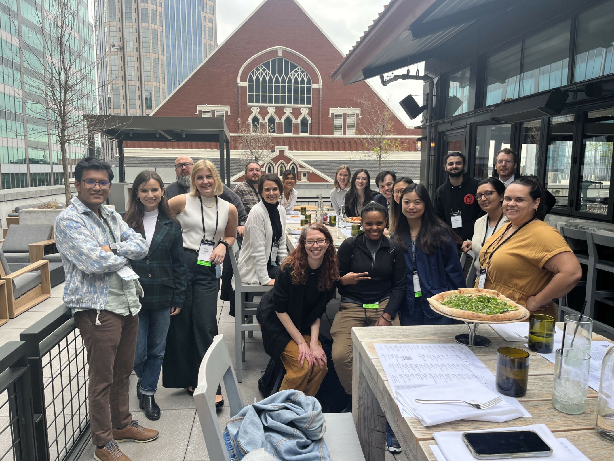 A top of people pose for a photo on a rooftop deck. 