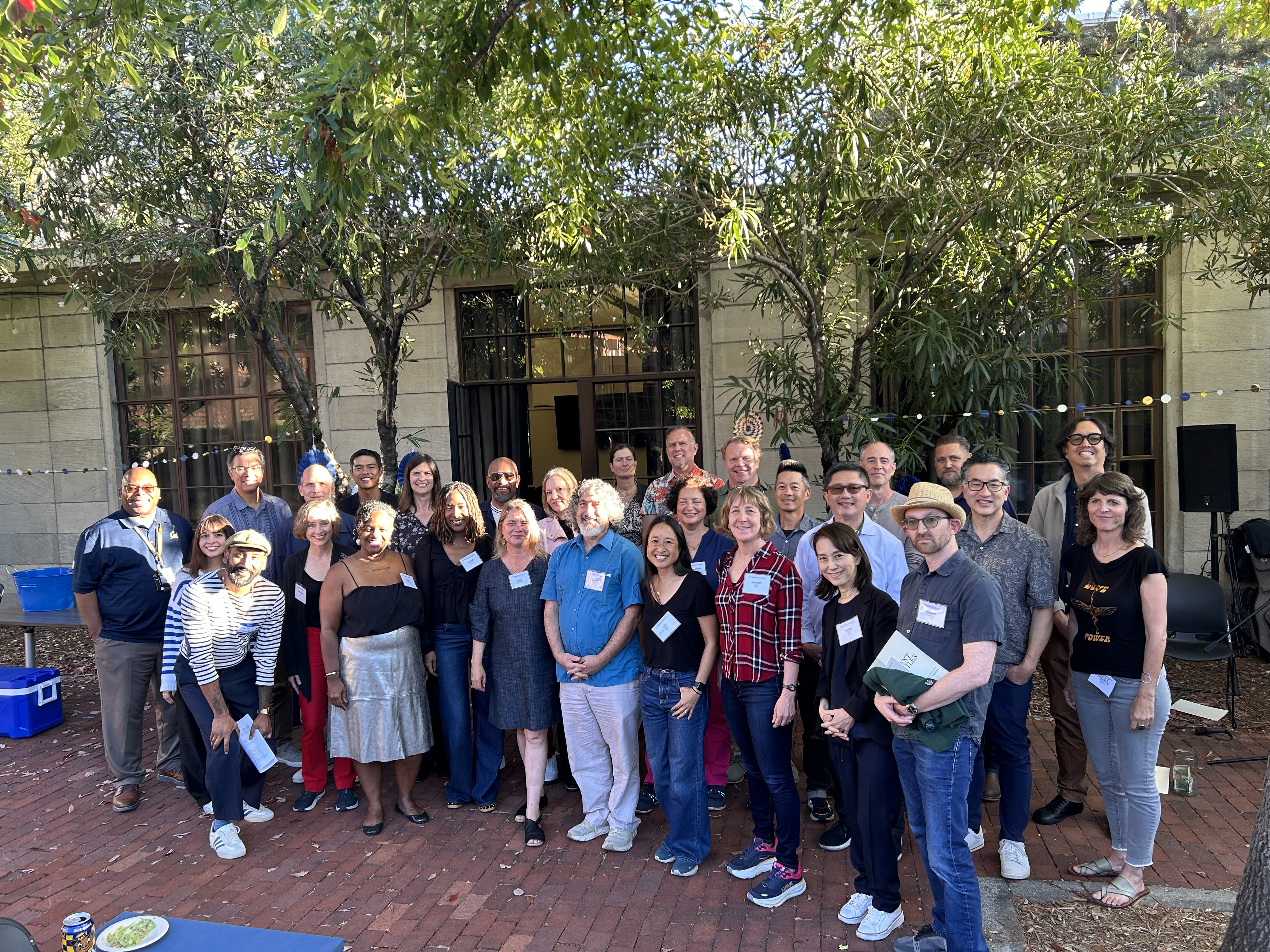 A group of people pose in the North Gate Hall courtyard.