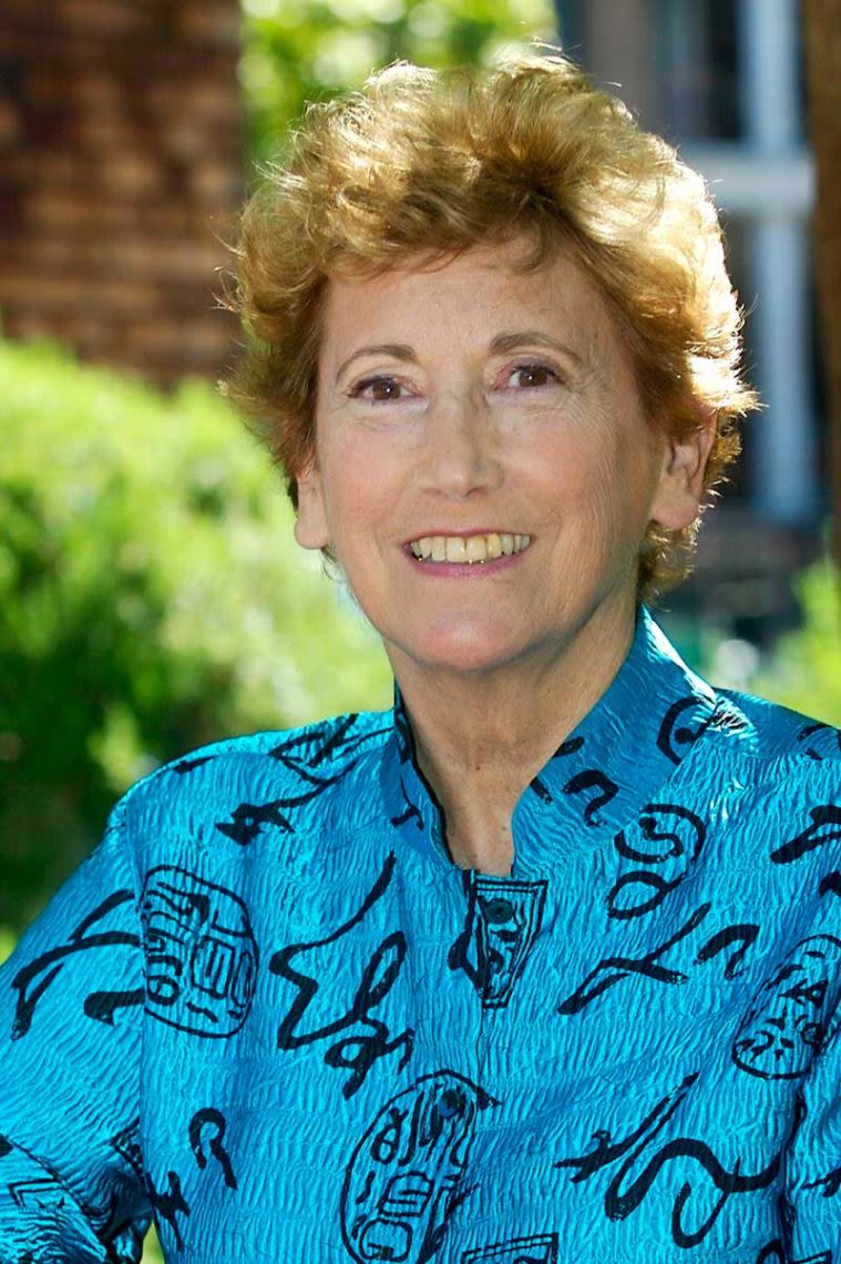 Joan Bieder headshot with a vibrant blue shirt.