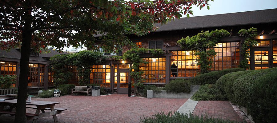 North Gate Hall Courtyard in the evening, with lights on in the building.